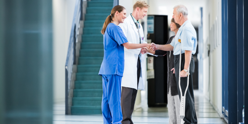 Doctor listening attentively to patient – illustrating patient-centered care which improves healthcare quality & patient satisfaction